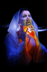 Artistic portrait of a lady in a white created by colored light
