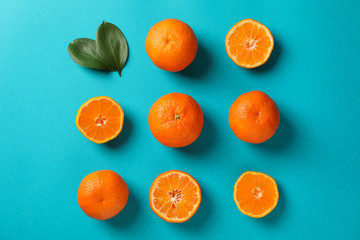 Flat lay with mandarins on turquoise background, top view