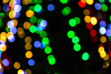 Bright colorful christmas bokeh isolated on black background, Xmas tree light texture, new year holiday decoration