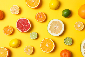 Juicy citrus fruits on yellow background, top view