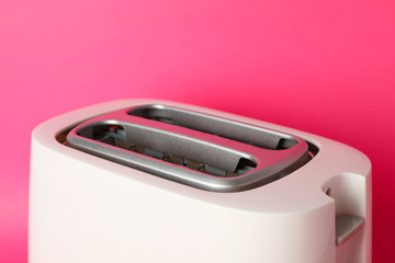 Toaster for bread on pink background, close up