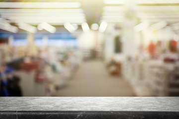Empty stone surface and blurred view of shopping mall. Space for design