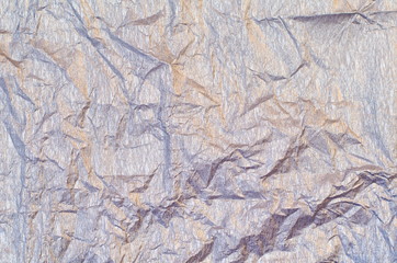 Background of silver and golden crepe tissue paper