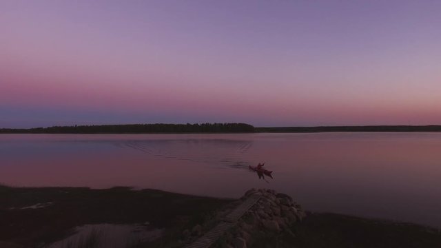 Person Approaching Shore In A Kayak. Aerial Drone View. Travel, Nature, Outdoor Activities Concept. Location: Northern Sweden, Scandinavia. July Of 2018. 