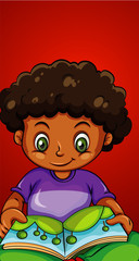 Happy boy reading book alone