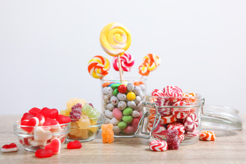 various candy and sweets on the table on a colored background. 