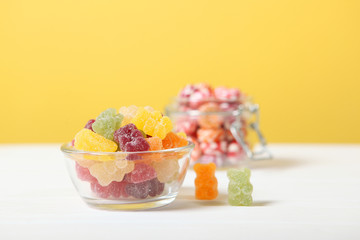 various candy and sweets on the table on a colored background. 