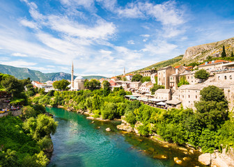 Fototapeta na wymiar Mostar city on the bank of Neretva river with stone houses and mosques in Bosnia and Herzegovina