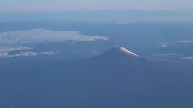 A bird's eye view close-up the Mount Fuji ( Mt. Fuji ) and blue sky. Scenery landscapes of the Fuji-Hakone-Izu National Park. Shizuoka Prefecture, Japan. 4K UHD