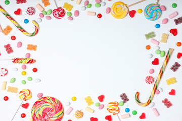 Candies and sweets on a light background, top view with place for text.