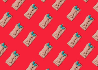Pattern on a red background of gifts in the style of furoshiki.