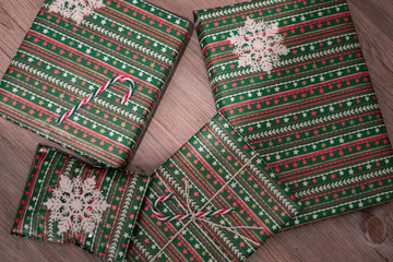 Christmas presents wrapped and stacked in wrapping paper with decoration