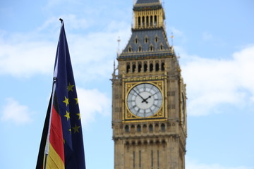 Fototapeta na wymiar Big Ben with EU and German flags beside it on a day of anti-Brexit protest