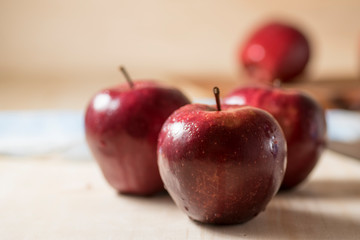Apples very red and bright, appetizing, on a table