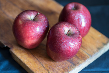 Apples very red and bright, appetizing, on a table