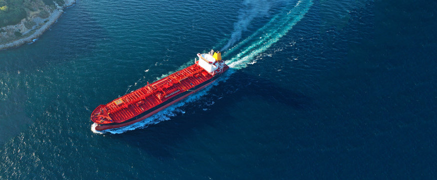 Aerial drone ultra wide panoramic photo of industrial crude oil tanker cruising open ocean deep blue sea