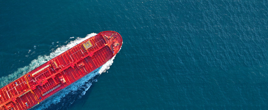 Aerial drone ultra wide panoramic photo of industrial fuel and petrochemical tanker ship cruising open ocean deep blue sea