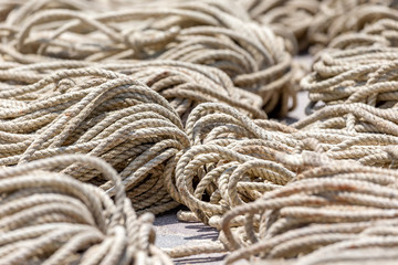 Old heavy duty rope laying outside on the asphalt