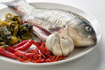 Raw ingredients for preparing Chinese style fish soup.