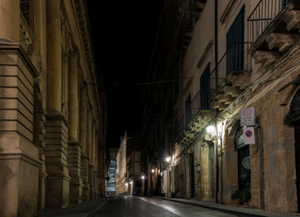 Fototapeta na wymiar Narrow street of the sicilian ceramic city Caltagirone at night, Sicily, south Italy