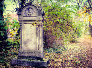 Munich, autumnal view with beautiful colors of Alter Nordfriedhof (old cemetery North), a dismiss...