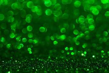 Christmas abstract texture, green sparkles bokeh shining background.