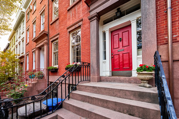 Naklejka premium a view of a row of historic brownstones in an iconic neighborhood of Manhattan, New York City