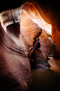 A woman rapelling in Keyhole Canyon, Zion National Park, Utah, USA