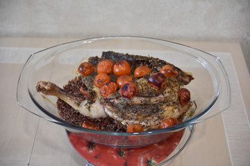 Baked chicken with basmati rice and vegetables on the glass dish