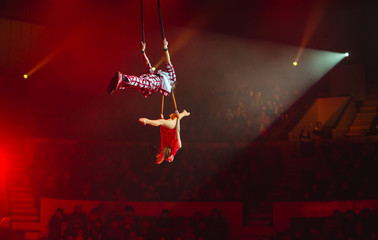 performance of aerialists in the circus arena.