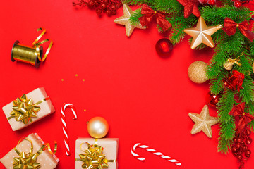 Christmas red background with herringbone and decor. Gold and red jewelry. Top view with space for copy.