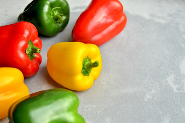 Multi-colored fresh bell peppers. Green, red and yellow vegetables. Organic healthy food concept. Top view, copy space.