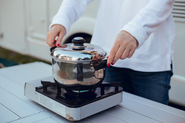 Close up Placing casserole in camping gas