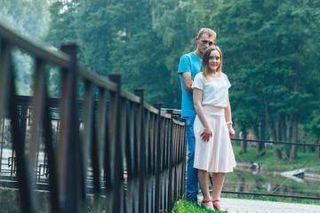 A guy and a girl are walking in the park
