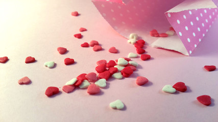 Valentine's Day. Frame made of gifts, candles, confetti on pink background. Valentines day background. Flat lay, top view, copy space.	