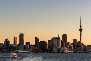 Auckland Sunset from sea horizontal with boat. - obrazy, fototapety, plakaty