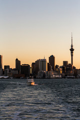 Fototapeta premium Auckland Sunset from sea vertical with boat.