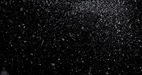 Natural white winter snowfall on a black background