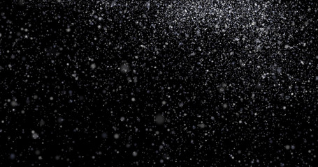 Natural white winter snowfall on a black background