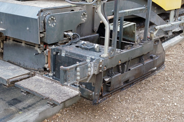 asphalt paver machine during road construction works