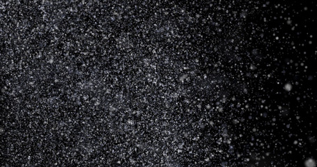 Natural white winter snowfall on a black background