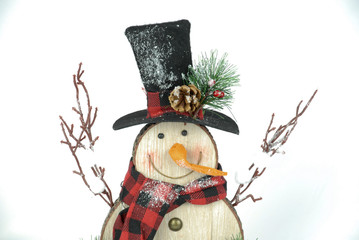 Rustic wooden snowman isolated on white. Snowman smiling with arms up. 