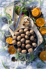 flat lay with  walnut on wooden board,   cracked nut with nutshell, Nutcracker, ebony, mandarin green grass on background