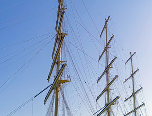Masts and rigging of a sailing ship against sky