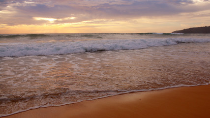 Obraz premium Beautiful sunset on the beach. The surf pounds the shore. Phuket, Thailand