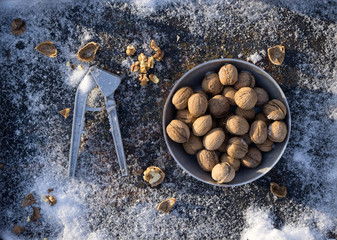 winter flat lay with  walnut,   Nutcracker  on iron background