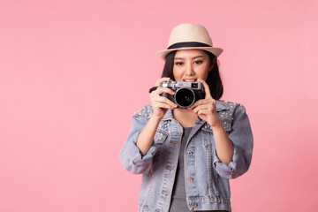 Tourist woman in summer casual clothes.Asian Smiling woman .Passenger traveling abroad to travel on pink background.Asian woman going to summer vacation.Travel trip funny.