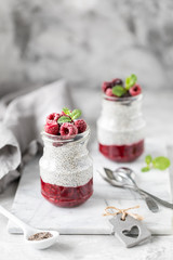 Chia pudding with fresh berries in glass jar. Concept of healthy eating, healthy lifestyle,...
