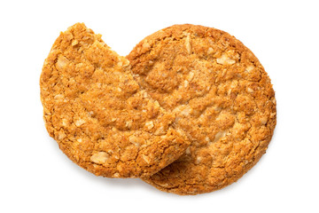 One and half crunchy oat and wholemeal biscuits isolated on white. Top view.
