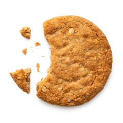 Partially eaten crunchy oat and wholemeal biscuit with crumbs isolated on white. Top view. - obrazy, fototapety, plakaty
